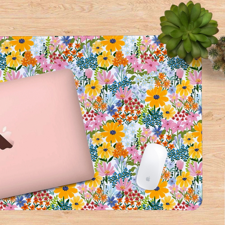 Summer Garden desk mat styled on a wooden desk with laptop and stationery